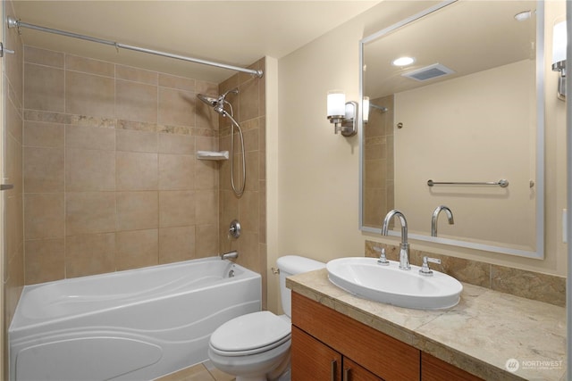 full bathroom with vanity, toilet, and tiled shower / bath combo