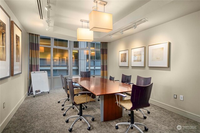 carpeted office featuring track lighting