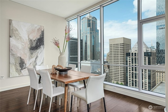 dining area featuring dark wood-type flooring and floor to ceiling windows