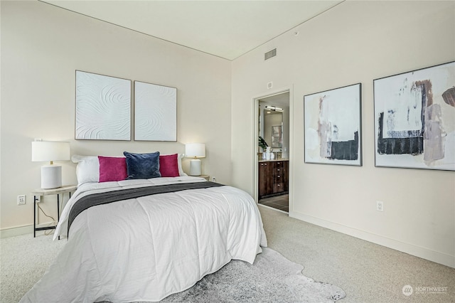 bedroom featuring carpet and connected bathroom