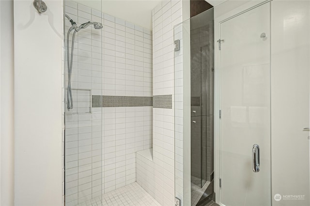 bathroom featuring a shower with door