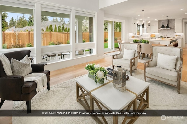 sunroom featuring a chandelier