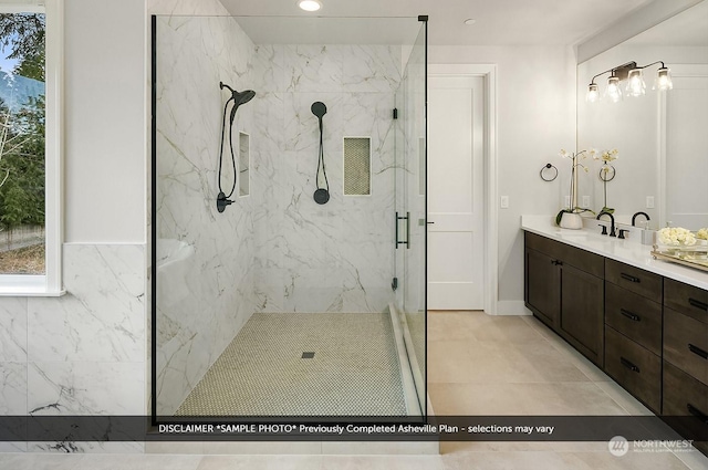 bathroom with walk in shower and vanity