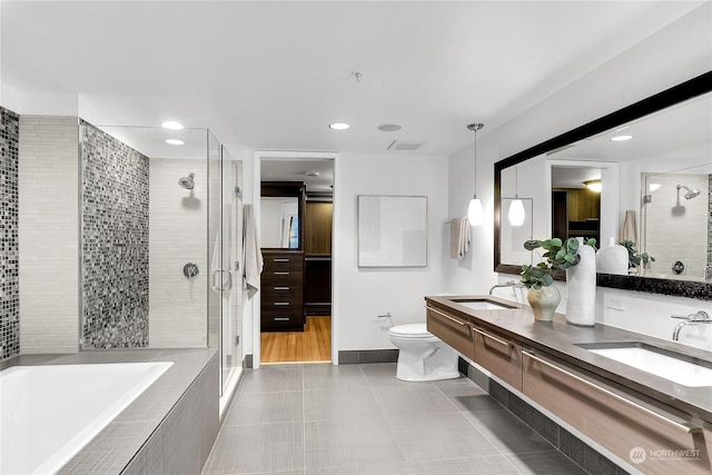 full bathroom featuring toilet, tile patterned flooring, vanity, and shower with separate bathtub