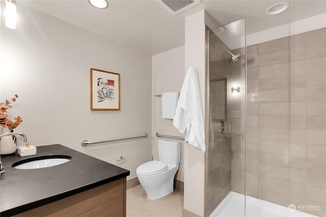 bathroom featuring toilet, walk in shower, tile patterned floors, and vanity