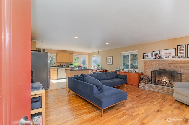 living room featuring a fireplace and light hardwood / wood-style floors