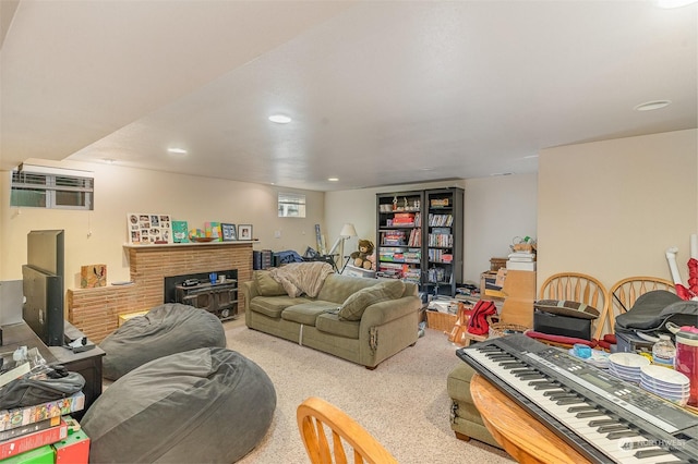 living room with light colored carpet, a wall mounted air conditioner, and a fireplace