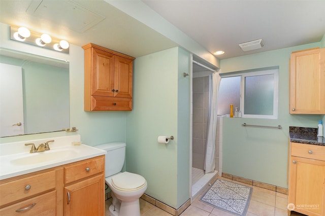 bathroom featuring tile patterned flooring, vanity, a shower with shower curtain, and toilet