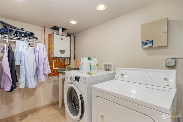 laundry area featuring separate washer and dryer, light tile patterned floors, and tankless water heater