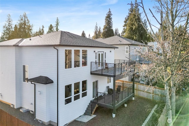 rear view of property with a balcony