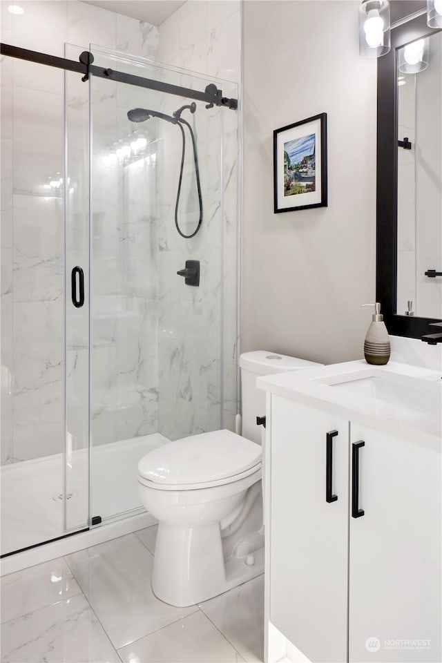 bathroom featuring vanity, toilet, and walk in shower