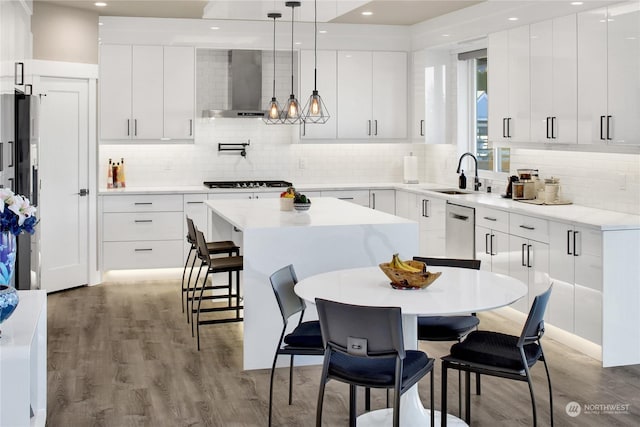 kitchen with sink, decorative light fixtures, and white cabinets