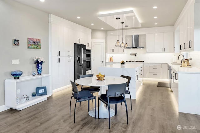 dining area featuring hardwood / wood-style flooring and sink