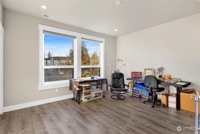 home office with dark hardwood / wood-style floors