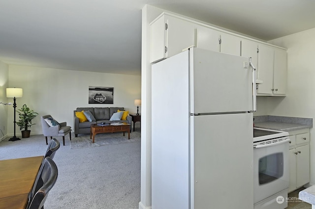 kitchen with white cabinetry, white appliances, and light carpet