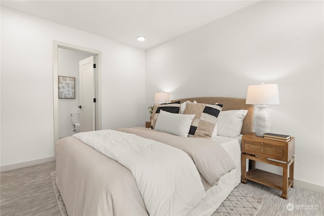 carpeted bedroom featuring ensuite bathroom