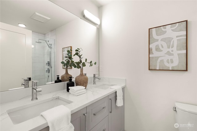 bathroom featuring vanity, toilet, and an enclosed shower