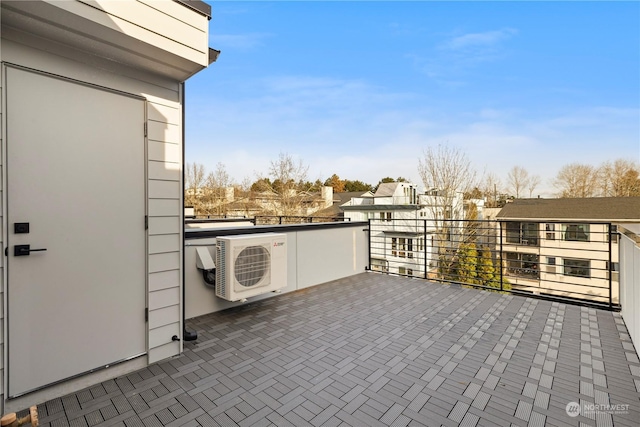 view of patio with a balcony and ac unit