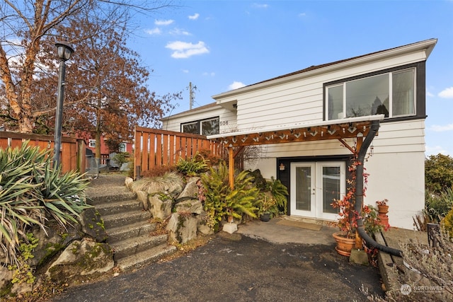 view of front of house with french doors and a pergola