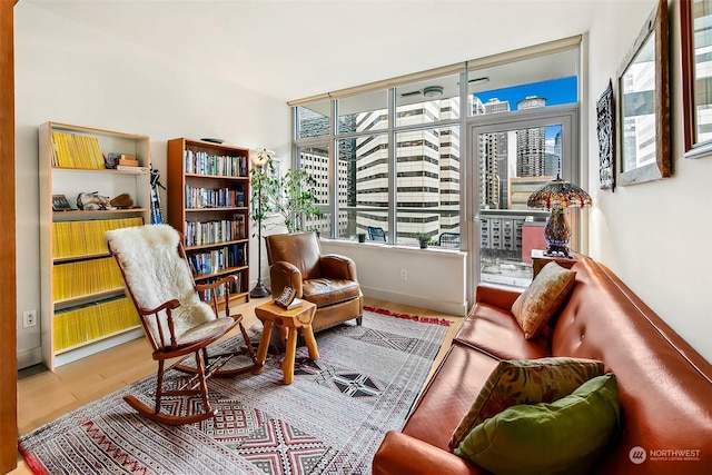 sitting room featuring wood-type flooring and plenty of natural light