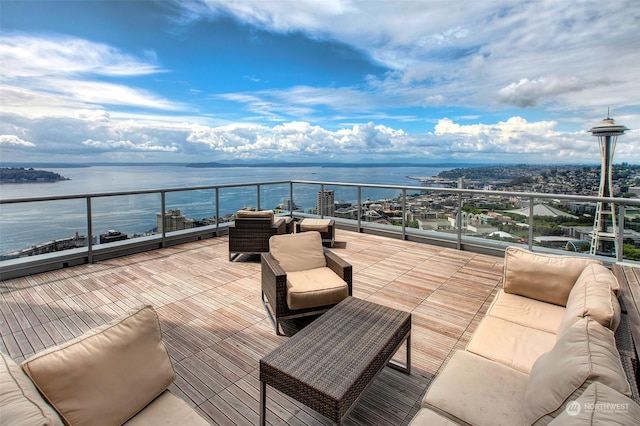 view of patio / terrace with a balcony, a water view, and outdoor lounge area