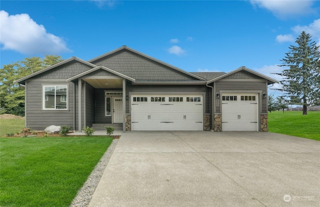 craftsman inspired home featuring a garage and a front lawn