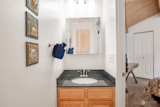 bathroom featuring vanity and vaulted ceiling