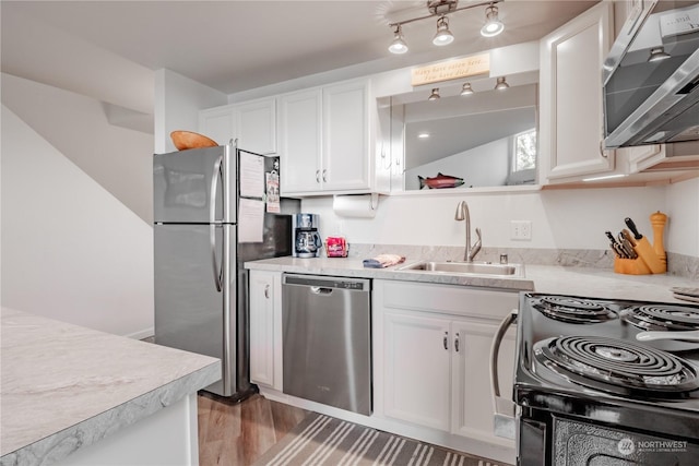 kitchen with sink, stainless steel appliances, and white cabinets