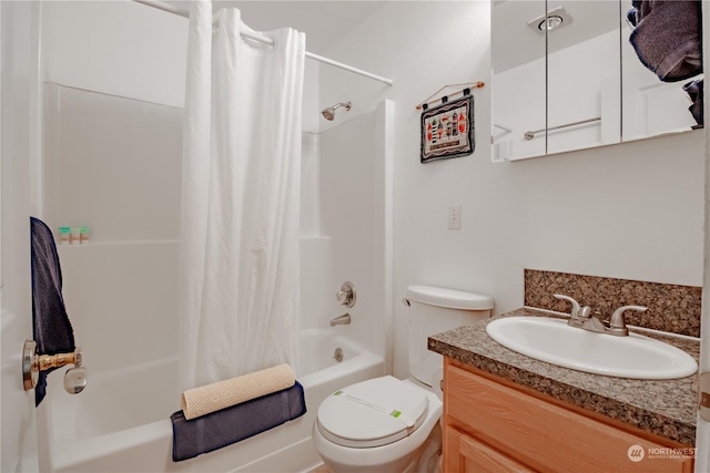 full bathroom with shower / bath combo, vanity, and toilet