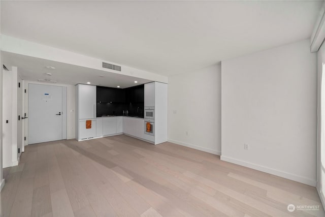 unfurnished living room with light wood-type flooring