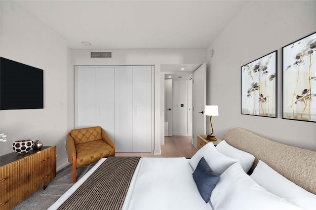 bedroom featuring wood-type flooring and a closet