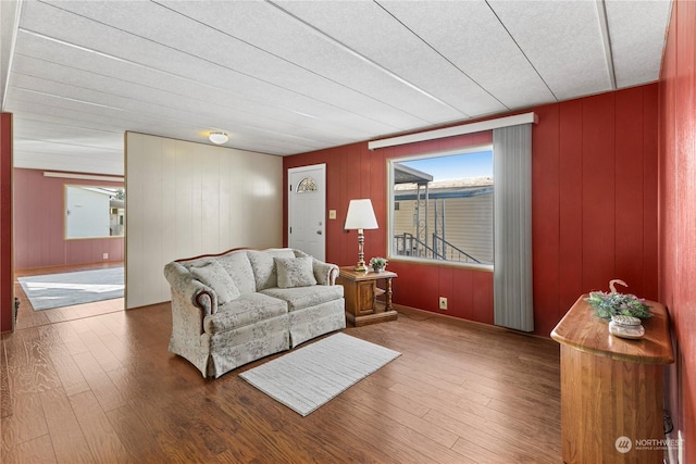 living room with wood-type flooring and wood walls