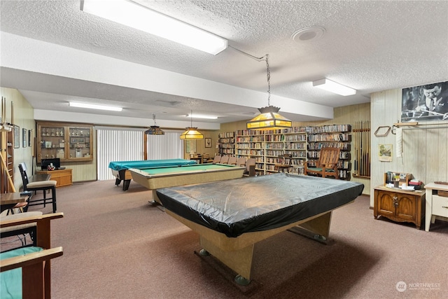 playroom with billiards, wood walls, a textured ceiling, and carpet