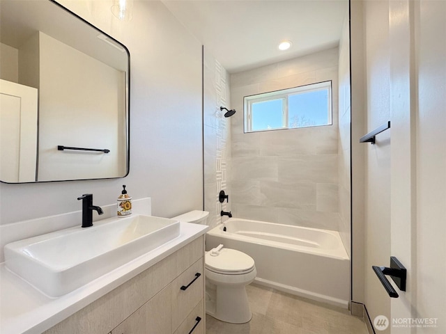 full bathroom featuring toilet, vanity, and tiled shower / bath