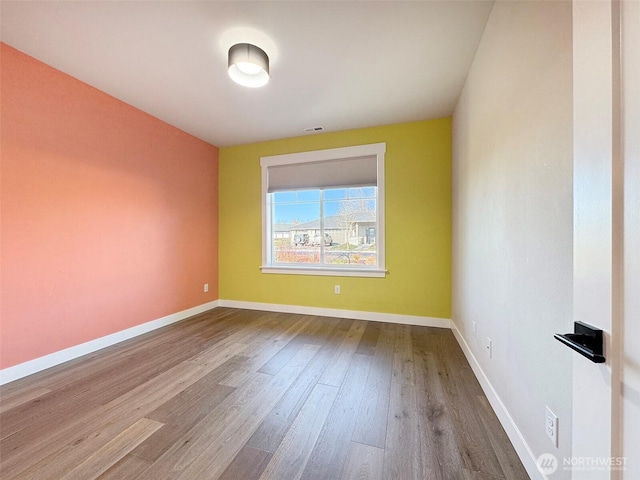 spare room featuring hardwood / wood-style flooring