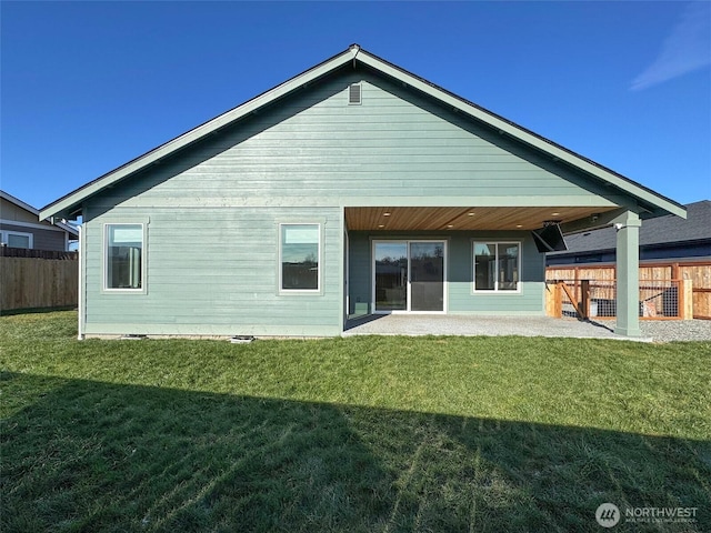 rear view of property with a lawn and a patio area