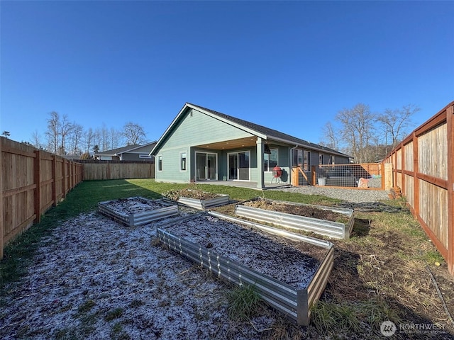 rear view of property featuring a lawn