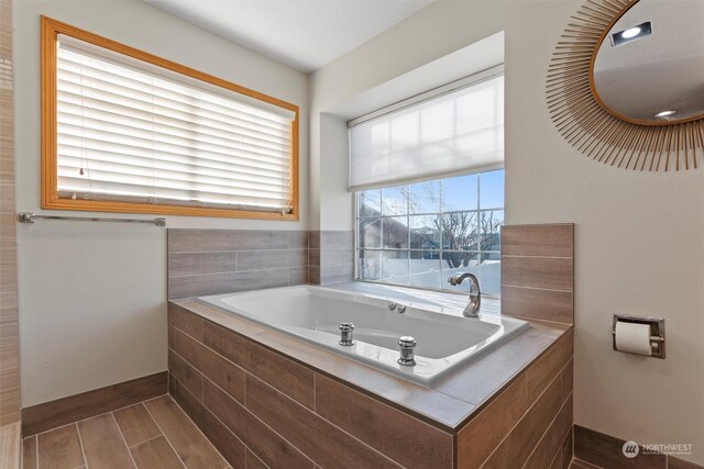 bathroom with tiled tub