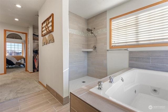 bathroom featuring separate shower and tub