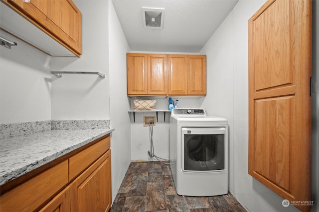 laundry area featuring washer / dryer and cabinets