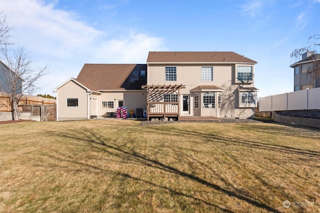 rear view of house featuring a wooden deck, a yard, and a pergola