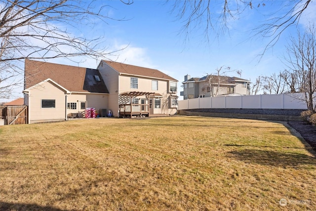 rear view of house with a yard and a pergola