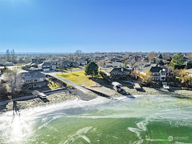 drone / aerial view featuring a beach view and a water view