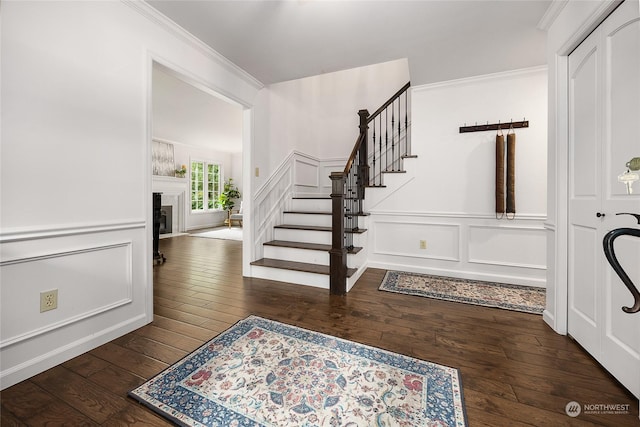 foyer with crown molding and dark hardwood / wood-style floors