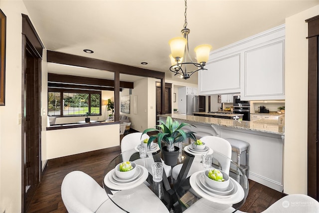 dining room with dark hardwood / wood-style flooring, a notable chandelier, and beam ceiling