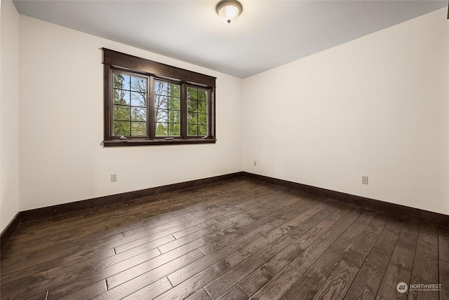 spare room with dark hardwood / wood-style floors