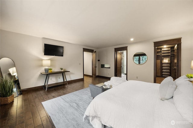 bedroom with dark hardwood / wood-style floors