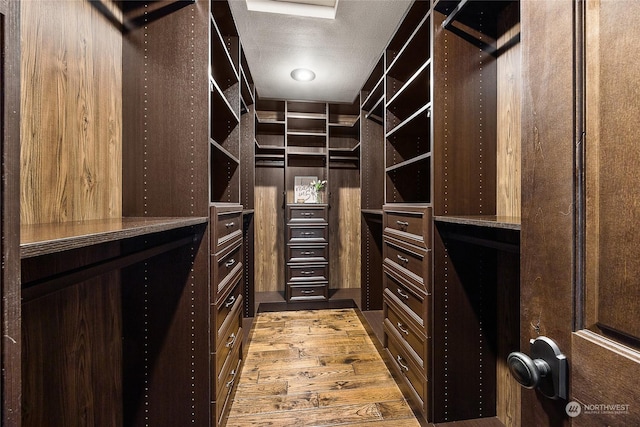 spacious closet featuring light wood-type flooring