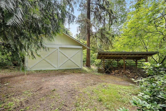 exterior space with a garage and an outbuilding