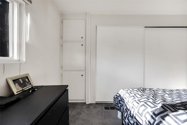 carpeted bedroom with a closet